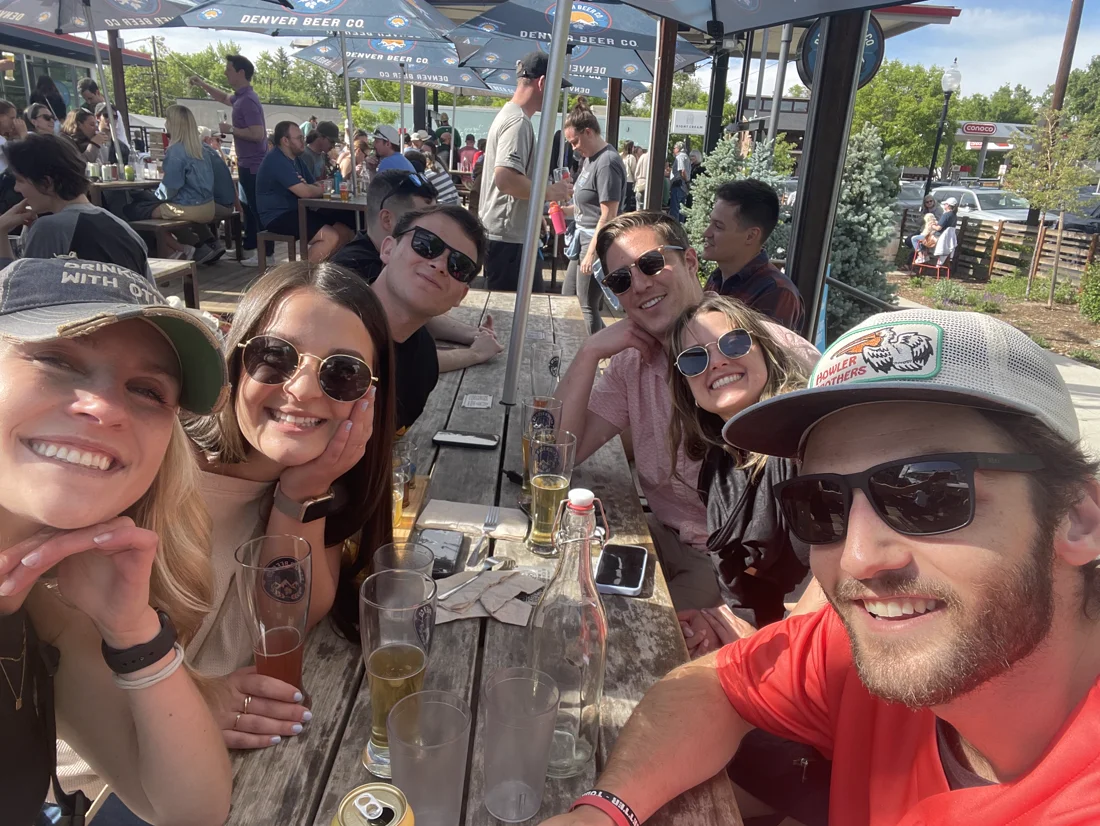 Kaitlyn, Jack, and friends sharing a sunny brewery patio