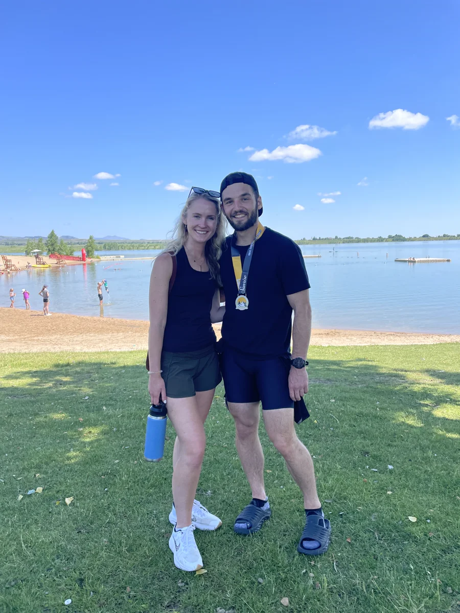 Kaitlyn and Jack beside the lake after a triathlon